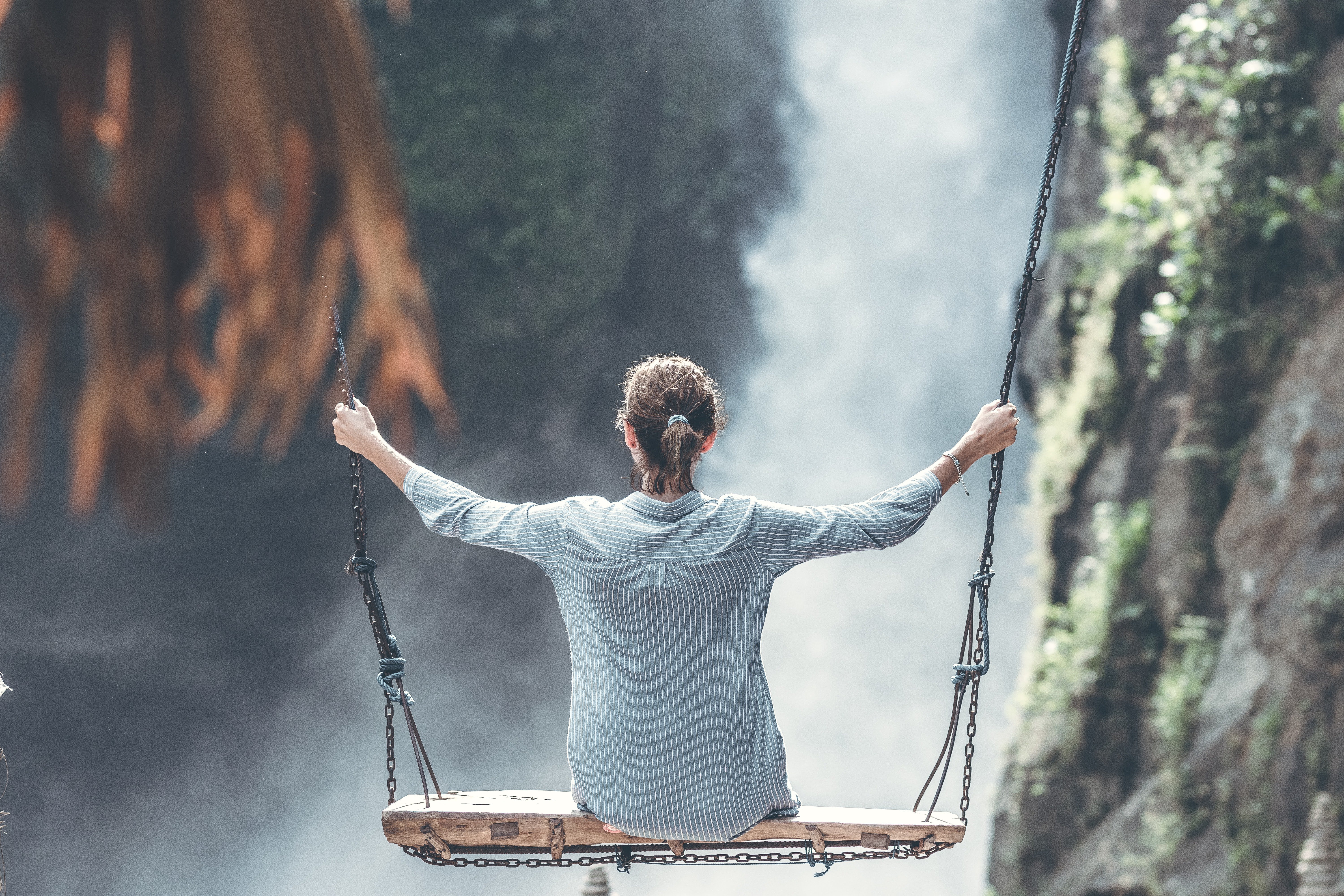 woman-riding-big-swing-in-front-of-waterfalls-1319795.jpg